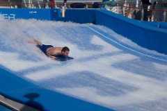 A brave soul tries out the Flowrider surfing simulation.